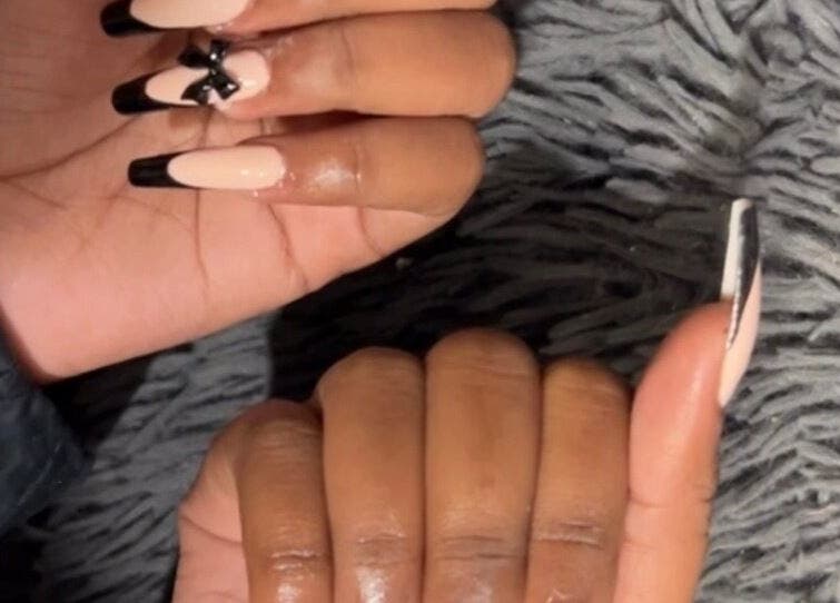 Elegant black-tipped nails with bow design at Kischa_co, Windhoek, Khomas Region, NA.