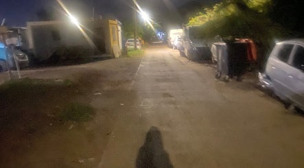 Dimly lit street near tewcutebraidingbylea in French Quarter, SX with parked cars and streetlights.