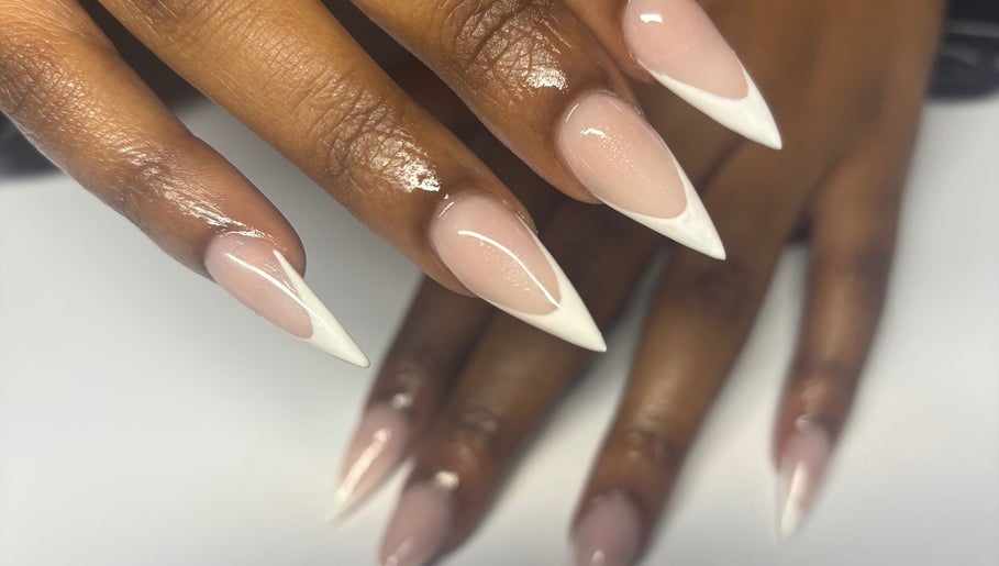 Stylish stiletto nails with French tips at Nailedbyjc in Grays, England, GB.