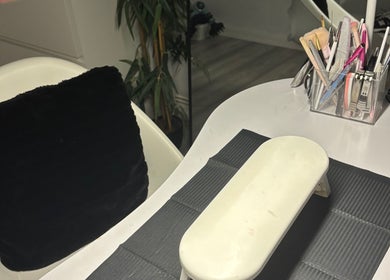 Nail station at Nailedbyjc in Grays, England, GB featuring tools and a cozy seating area.