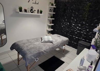 Relaxing spa room at WaxByLora in London, England, GB with massage bed and modern decor.