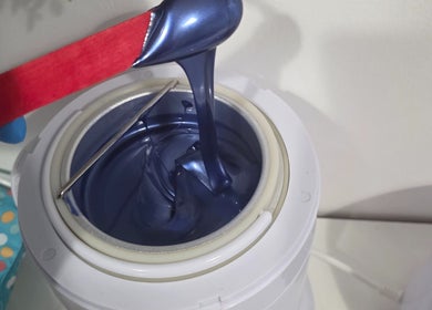 Close-up of blue wax being prepared at WaxByLora, London, England, GB.