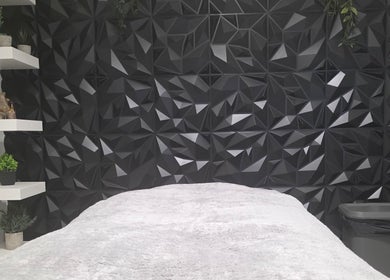 Elegant treatment room at WaxByLora, London, England, GB with geometric decor and sleek design.