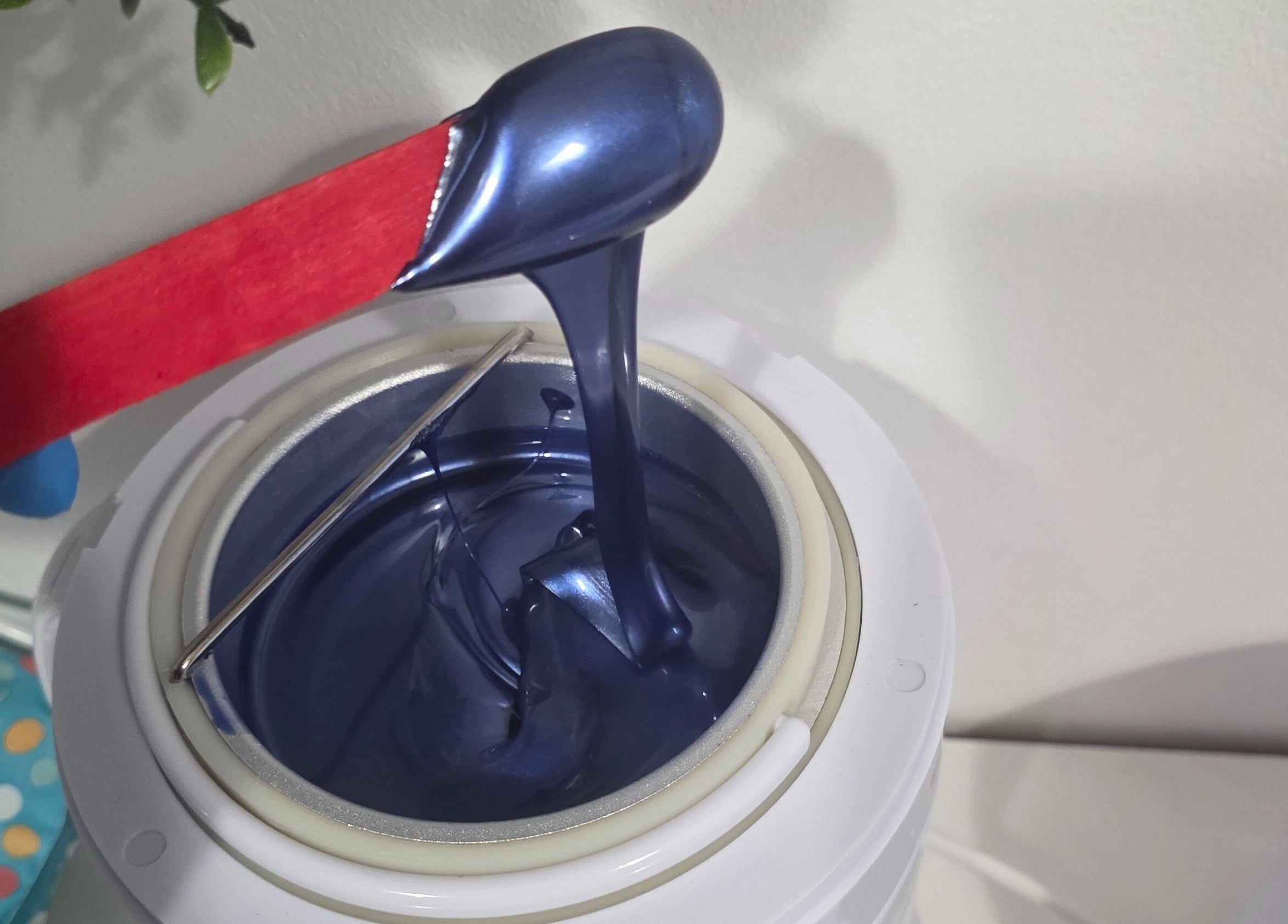 Luxurious blue wax in applicator at WaxByLora, London, England, GB. Perfect for premium waxing services.