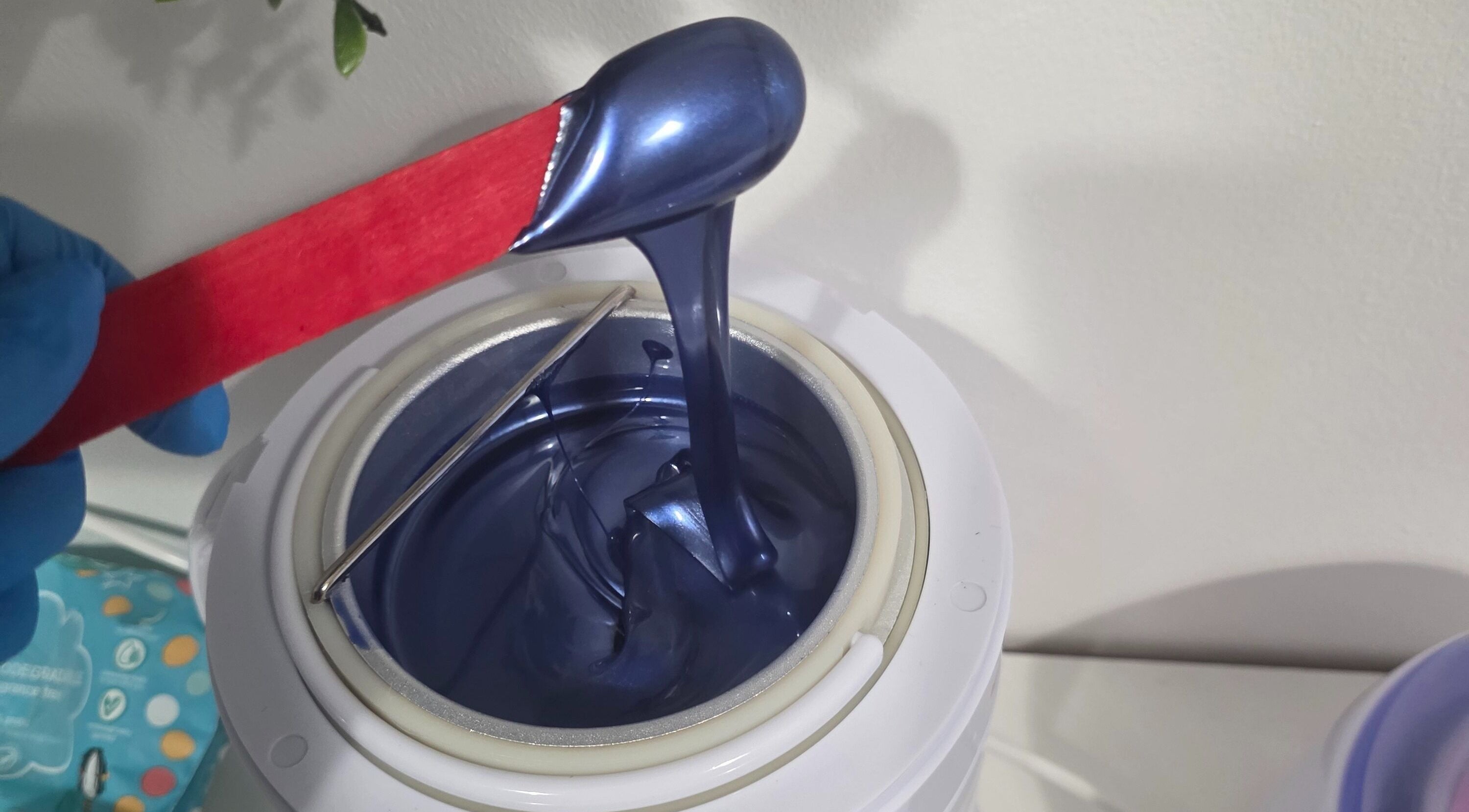Luxurious blue wax in applicator at WaxByLora, London, England, GB. Perfect for premium waxing services.