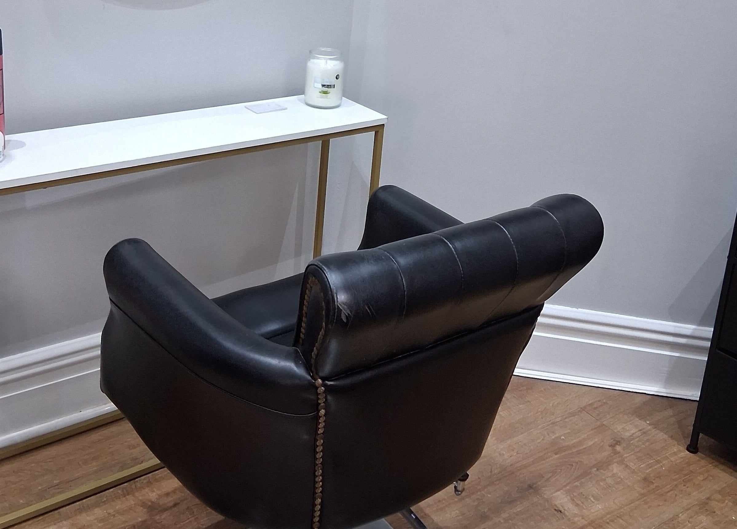 Modern hair salon chair at Hair by Lorraine, 5 The Arcade, Llanelli, Wales, GB, showcasing elegance and comfort.