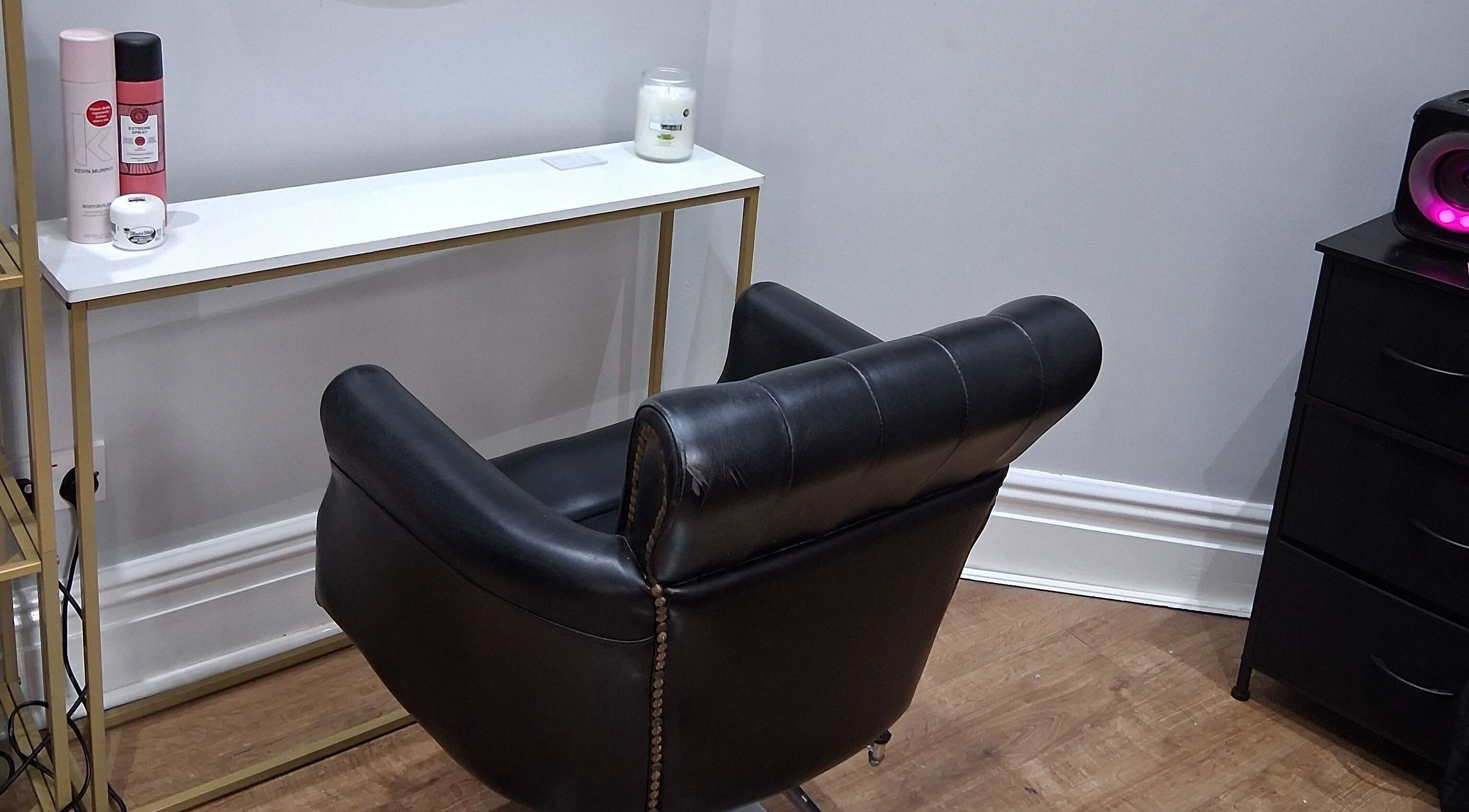 Modern hair salon chair at Hair by Lorraine, 5 The Arcade, Llanelli, Wales, GB, showcasing elegance and comfort.