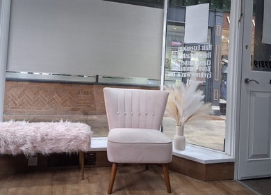 Stylish seating area at Hair by Lorraine 5 The Arcade, Llanelli, Wales, GB, featuring plush chair and decor.