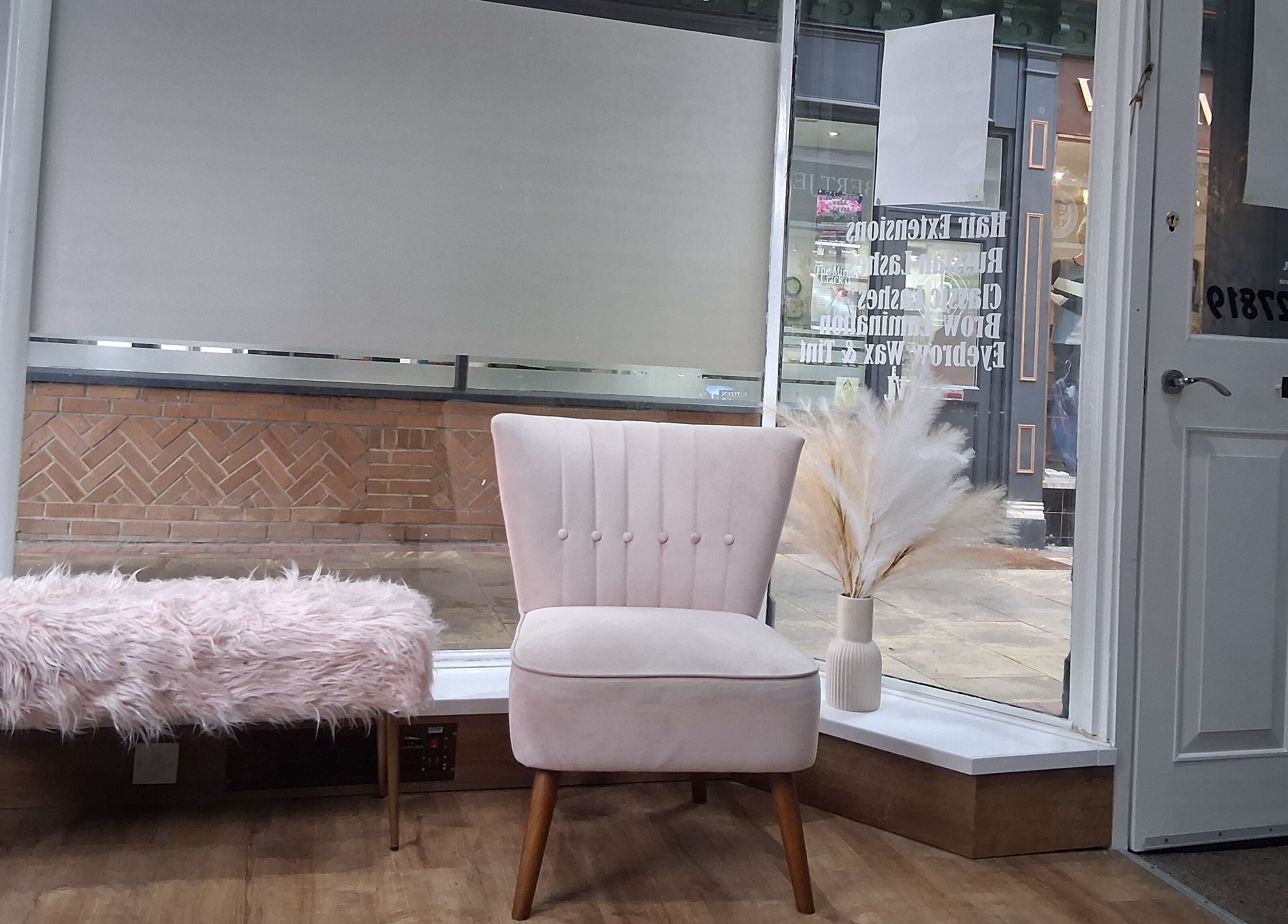 Stylish seating area at Hair by Lorraine 5 The Arcade, Llanelli, Wales, GB, featuring plush chair and decor.