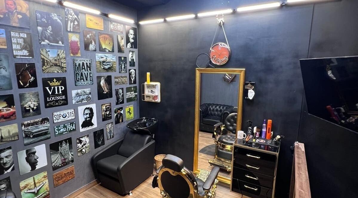 Stylish interior of MAN CAVE SALON in Doha, Doha Municipality, QA with black decor and wall art.