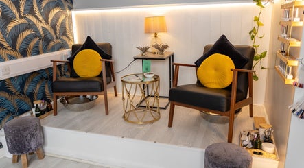 Cozy seating area at Morgan and Company Hair and Beauty, Nottingham, England, GB with elegant decor.