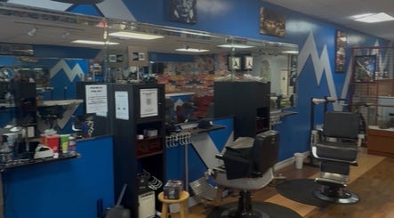 Interior of KROWNED by P, a modern salon in Tamarac, Florida, US with blue walls and barber chairs.