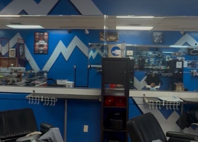 Modern interior of KROWNED by P in Tamarac, Florida, US with sleek blue and white decor.