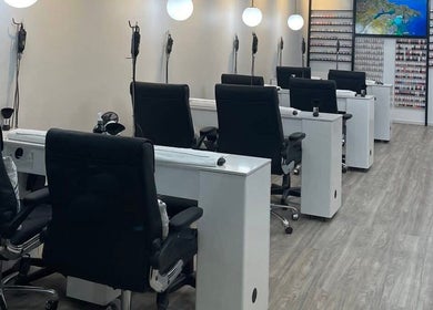 Modern nail salon interior at Professionail Takapuna, Auckland, NZ with manicure stations and stylish decor.