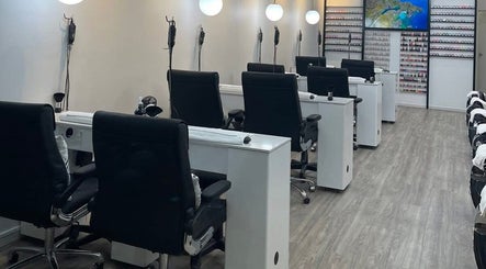 Modern nail salon interior at Professionail Takapuna, Auckland, NZ with manicure stations and stylish decor.