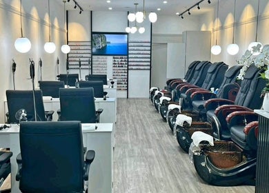 Professionail Takapuna's serene nail salon interior in Auckland, NZ featuring sleek black chairs and ambient lighting.