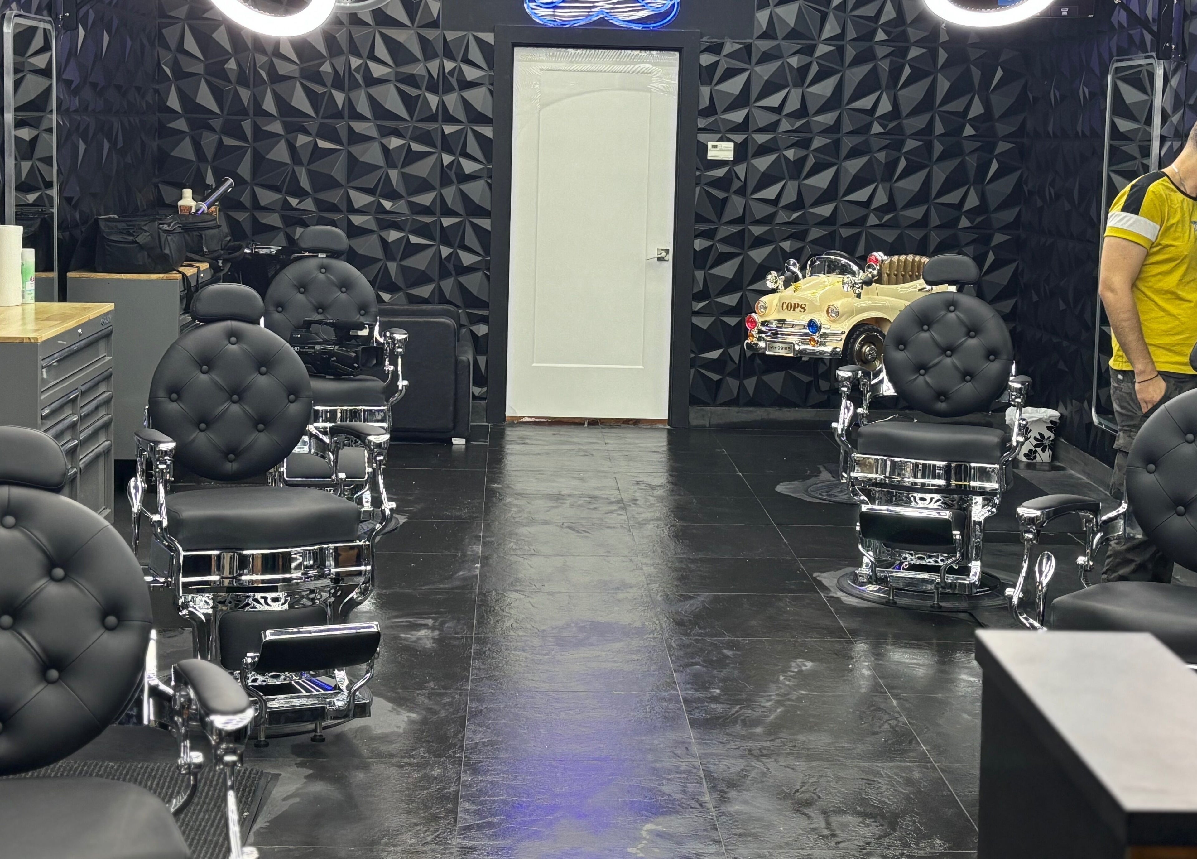 Modern barbershop at Joseph Howe, Halifax, Nova Scotia, CA with sleek black chairs and stylish decor.