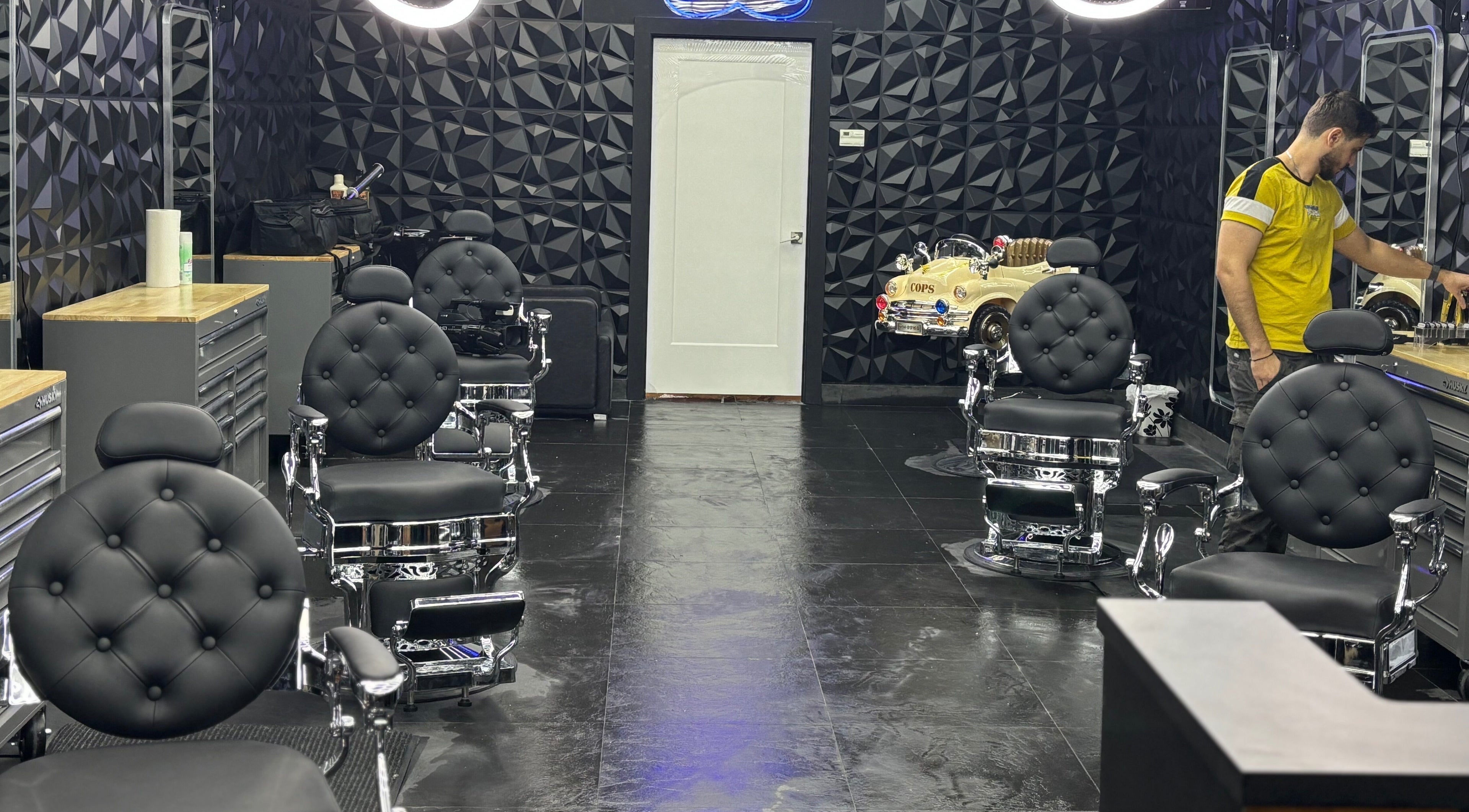 Modern barbershop at Joseph Howe, Halifax, Nova Scotia, CA with sleek black chairs and stylish decor.