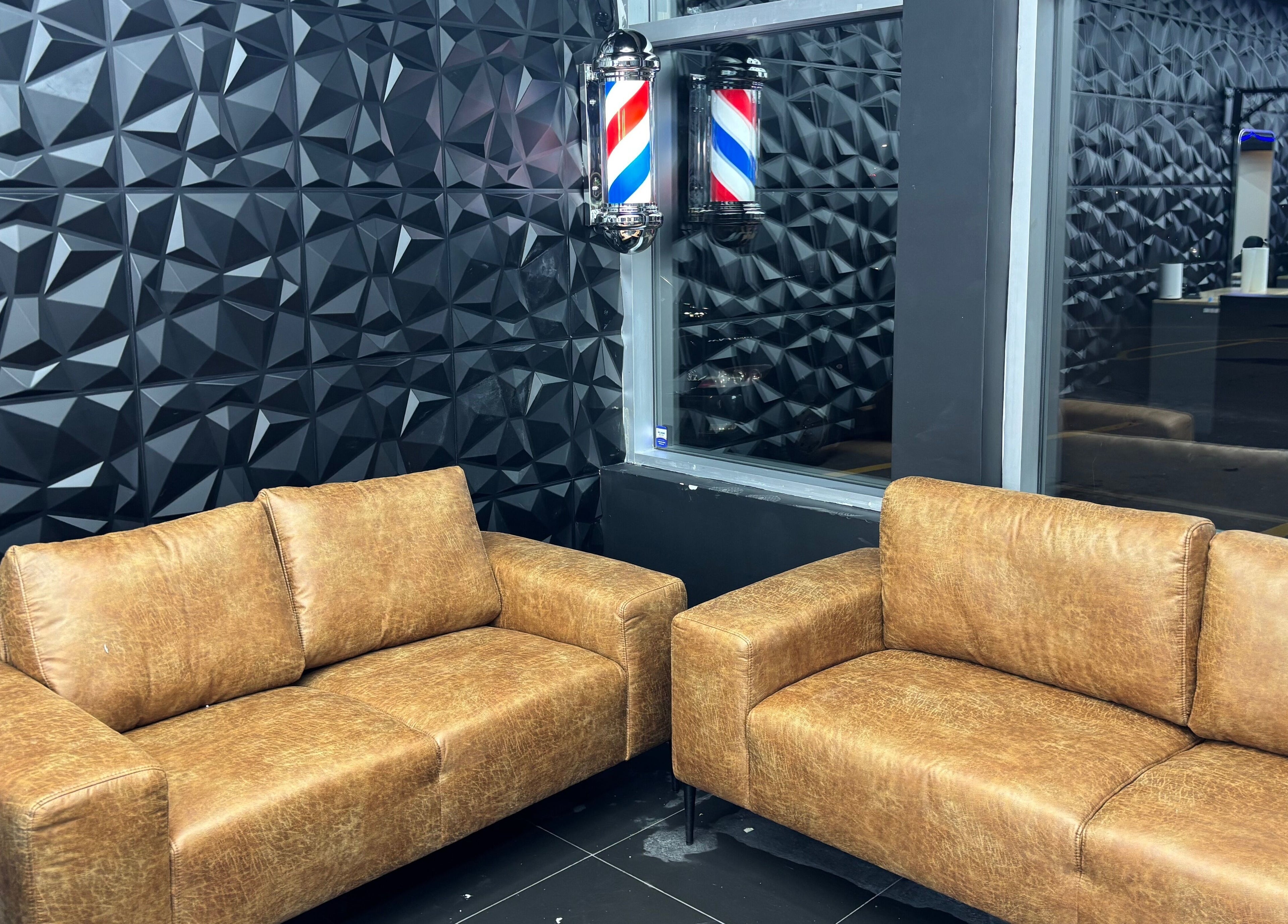 Stylish brown sofas in Joseph Howe, Halifax, Nova Scotia, CA, with a modern textured wall.