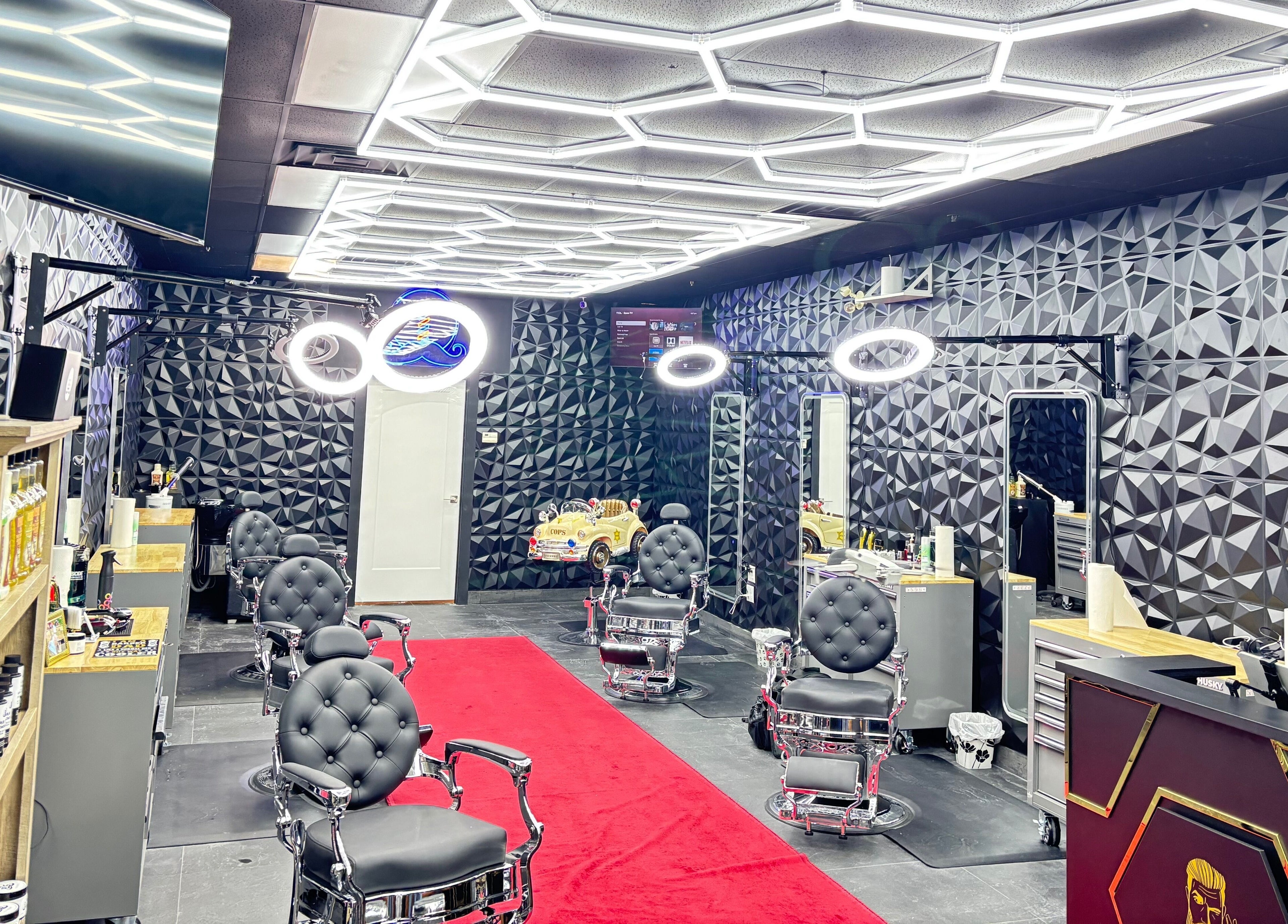 Modern salon interior at Joseph Howe, Halifax, Nova Scotia, CA with geometric walls and red carpet.