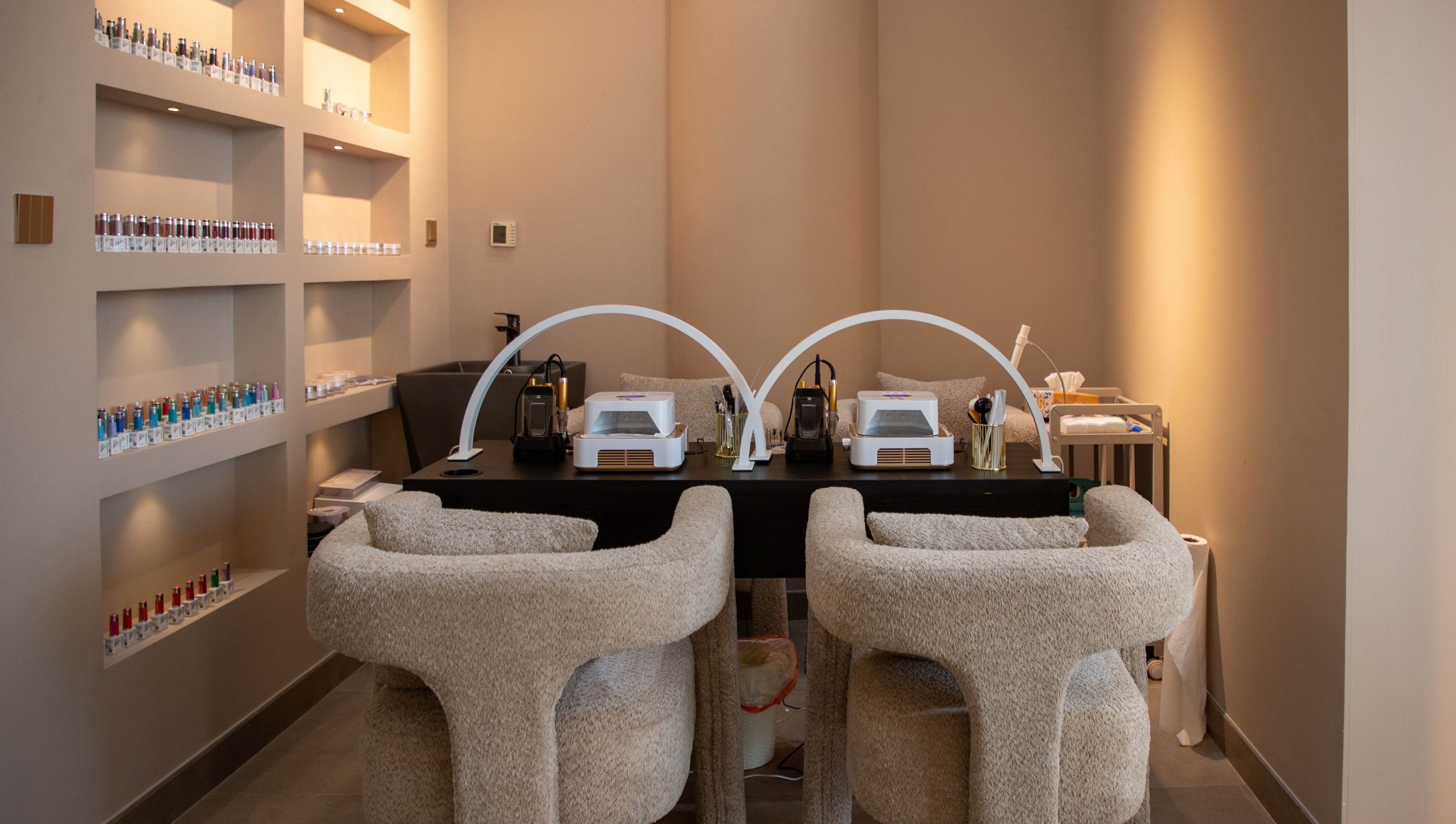 Elegant manicure station at So Chic Paris in Dubai, Dubai, AE showcasing modern design and nail polish display.