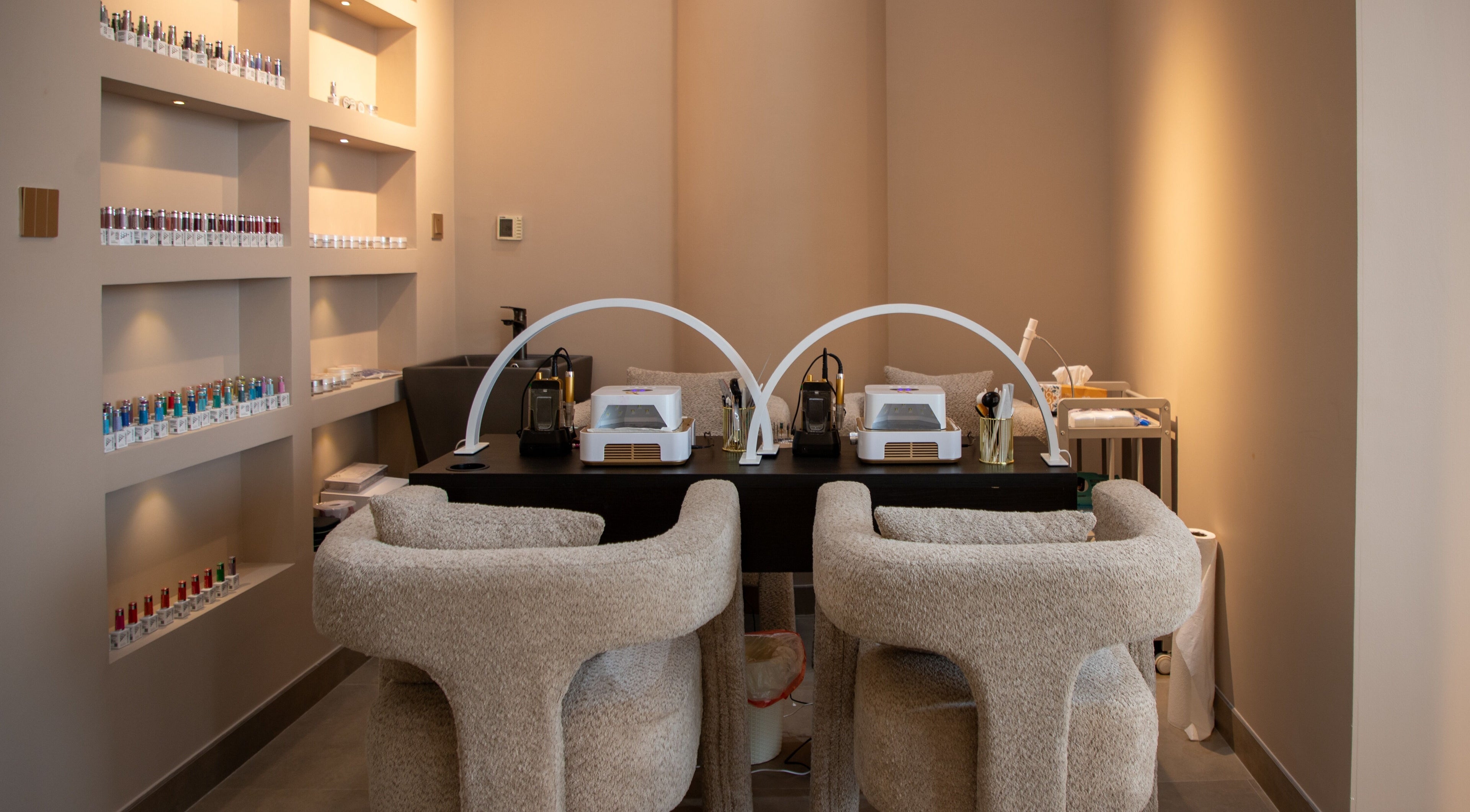Elegant manicure station at So Chic Paris in Dubai, Dubai, AE showcasing modern design and nail polish display.