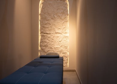 Serene massage room at So Chic Paris, Dubai, Dubai, AE with ambient lighting and a plush massage table.