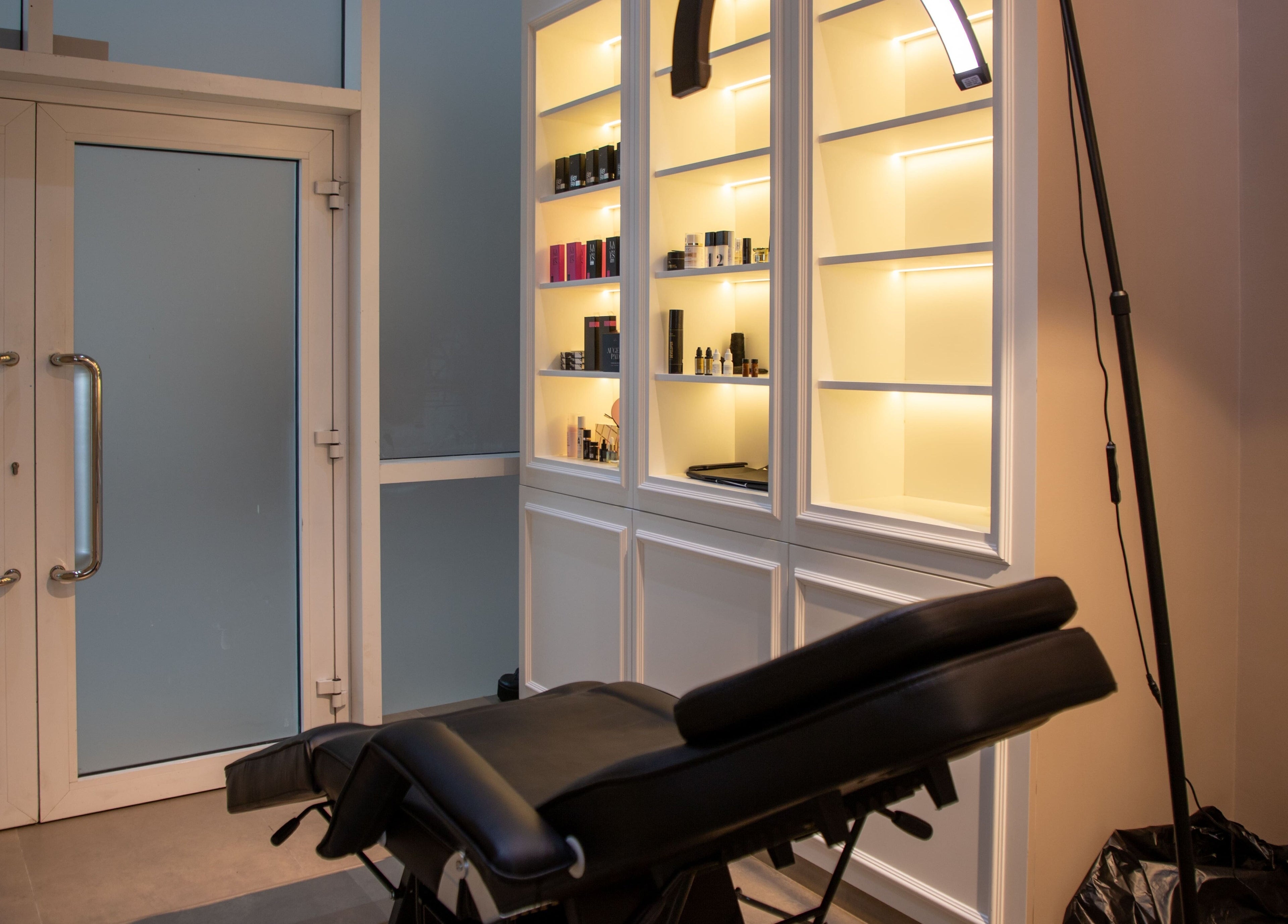 Luxurious treatment room at So Chic Paris, Dubai, Dubai, AE, featuring a massage chair and illuminated shelves.