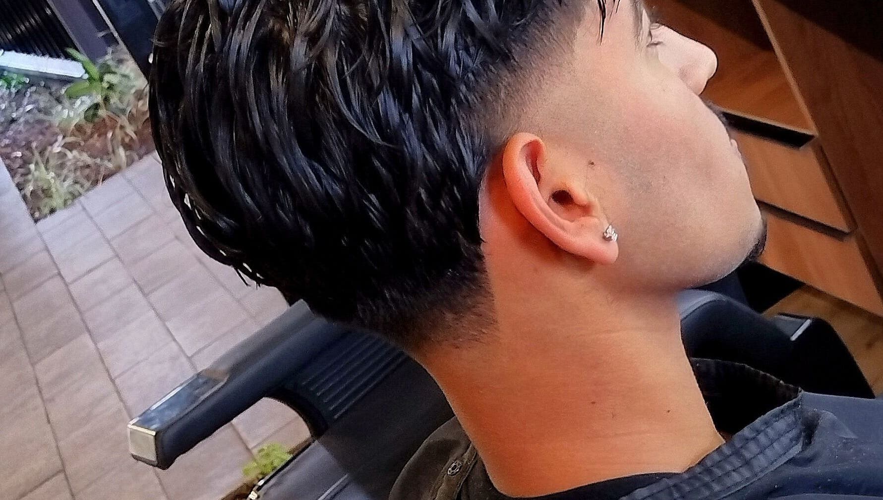 Close-up of a stylish haircut with a fade at Legacy in Midrand, Gauteng, ZA. Modern salon style.
