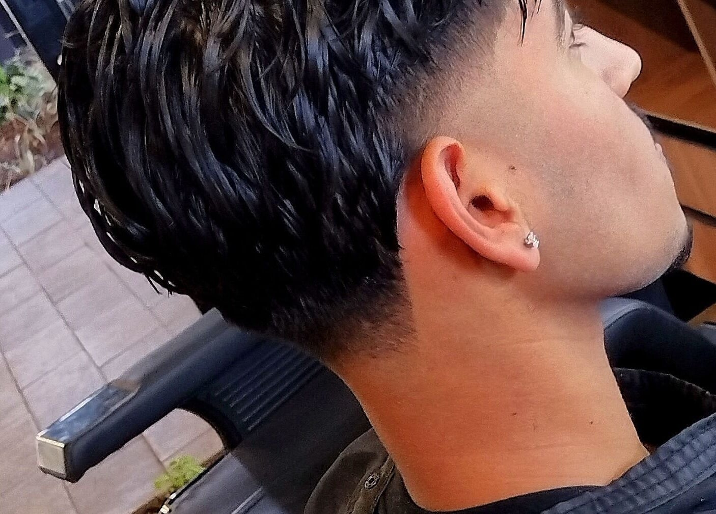 Close-up of a stylish haircut with a fade at Legacy in Midrand, Gauteng, ZA. Modern salon style.