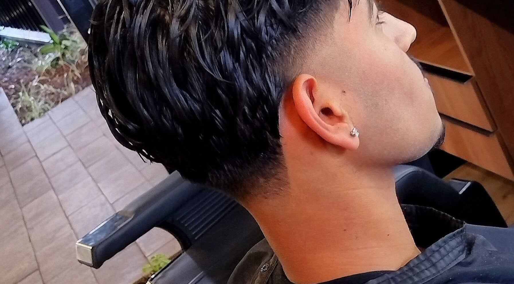 Close-up of a stylish haircut with a fade at Legacy in Midrand, Gauteng, ZA. Modern salon style.