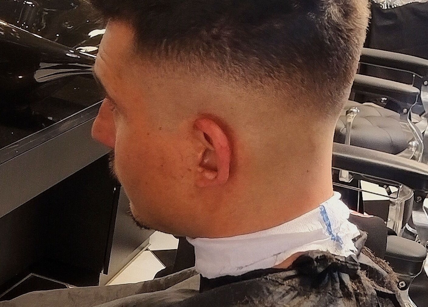 A fresh men's haircut at Legacy, Midrand, Gauteng, ZA, showcasing sharp styling chairs.