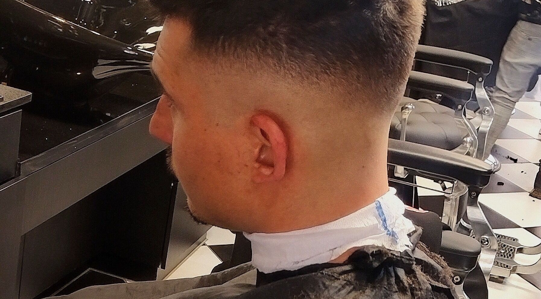 A fresh men's haircut at Legacy, Midrand, Gauteng, ZA, showcasing sharp styling chairs.