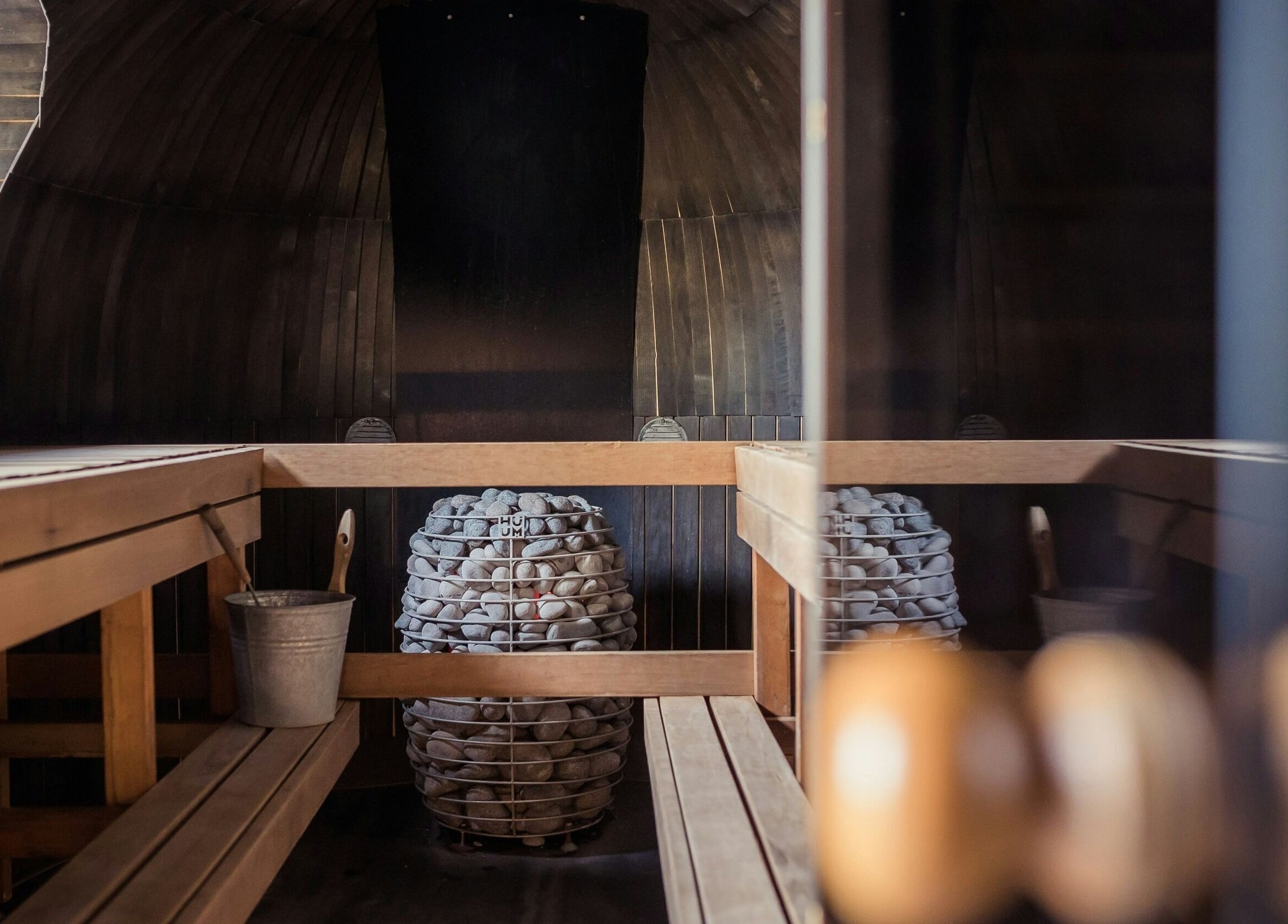 Cozy sauna room at Sari Kayangan Spa & Wellness, Sepang, Selangor, MY, featuring wooden benches and stone heater.