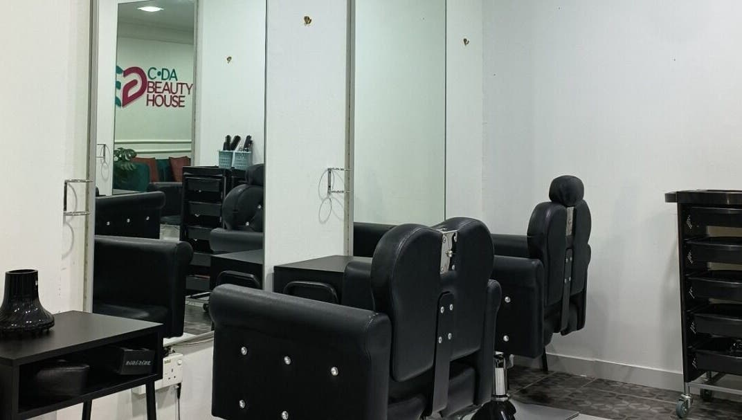 Modern salon interior at Cda Beauty House, Klang, Selangor, MY featuring sleek black chairs and mirrors.
