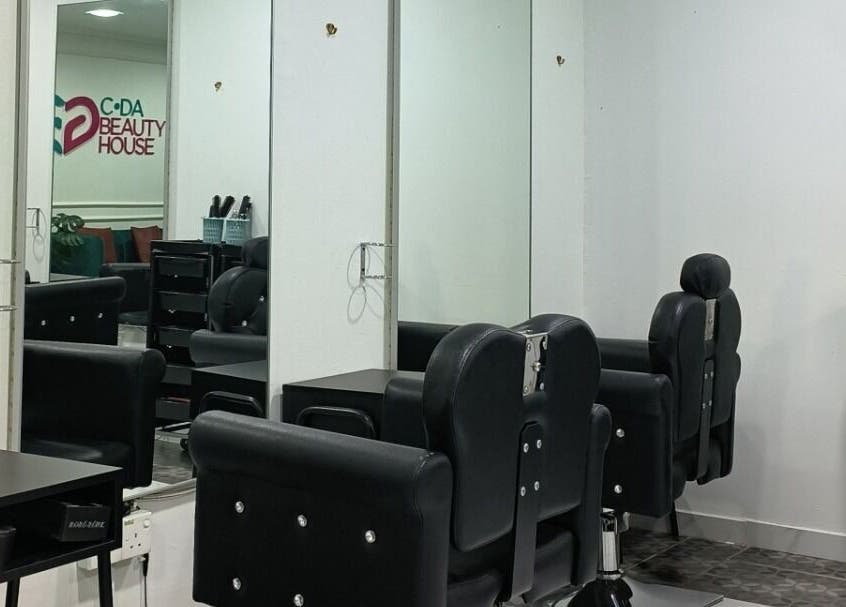 Modern salon interior at Cda Beauty House, Klang, Selangor, MY featuring sleek black chairs and mirrors.