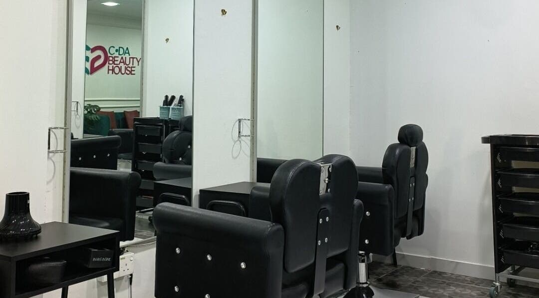 Modern salon interior at Cda Beauty House, Klang, Selangor, MY featuring sleek black chairs and mirrors.