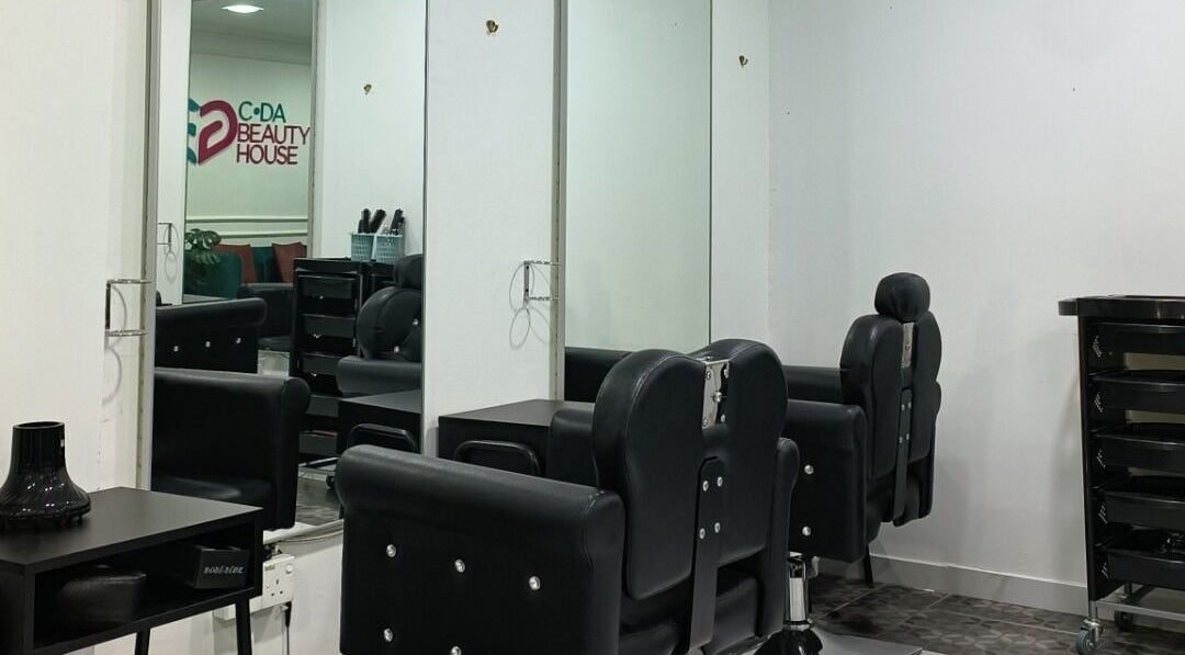 Modern salon interior at Cda Beauty House, Klang, Selangor, MY featuring sleek black chairs and mirrors.