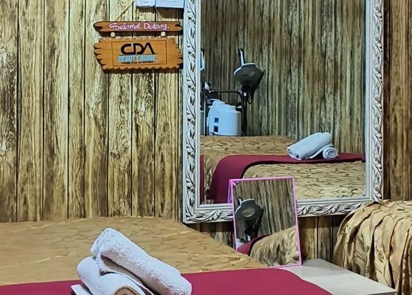 Comfortable massage room at Cda Beauty House in Klang, Selangor, MY, featuring warm decor and relaxing ambiance.
