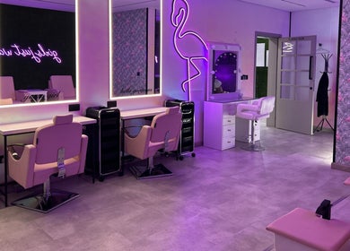 Chic interior of Villa 8 Ladies Salon and Spa in Dubai, Dubai, AE with pink accents and neon lights.