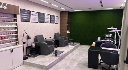 Stylish nail salon at Villa 8 Ladies Salon and Spa, Dubai, Dubai, AE with modern chairs and nail polish display.
