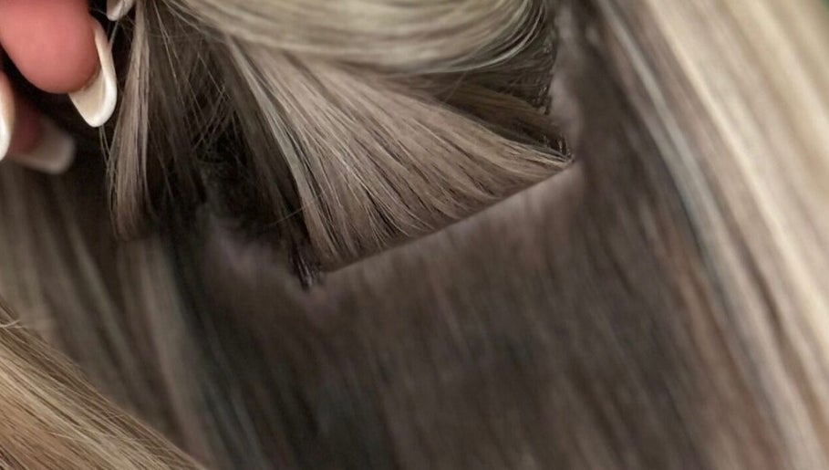 Close-up of hair extensions at Bella Extensions, Sandbach, England, GB showcasing sleek, blonde textures.