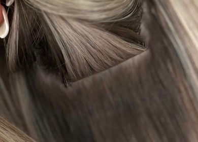 Close-up of hair extensions at Bella Extensions, Sandbach, England, GB showcasing sleek, blonde textures.