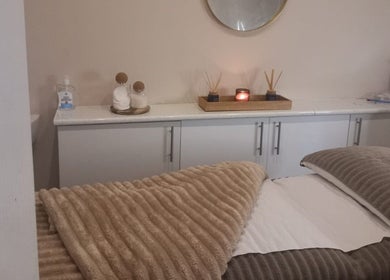 Elegant spa room at CKB Skin Clinic, Glasgow, Scotland, GB, with a massage table and calming decor.