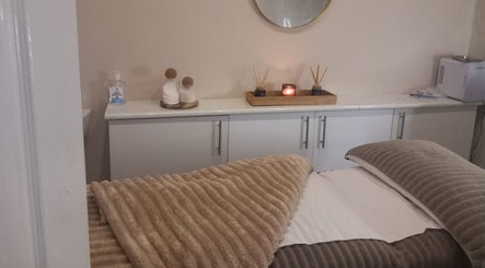 Elegant spa room at CKB Skin Clinic, Glasgow, Scotland, GB, with a massage table and calming decor.