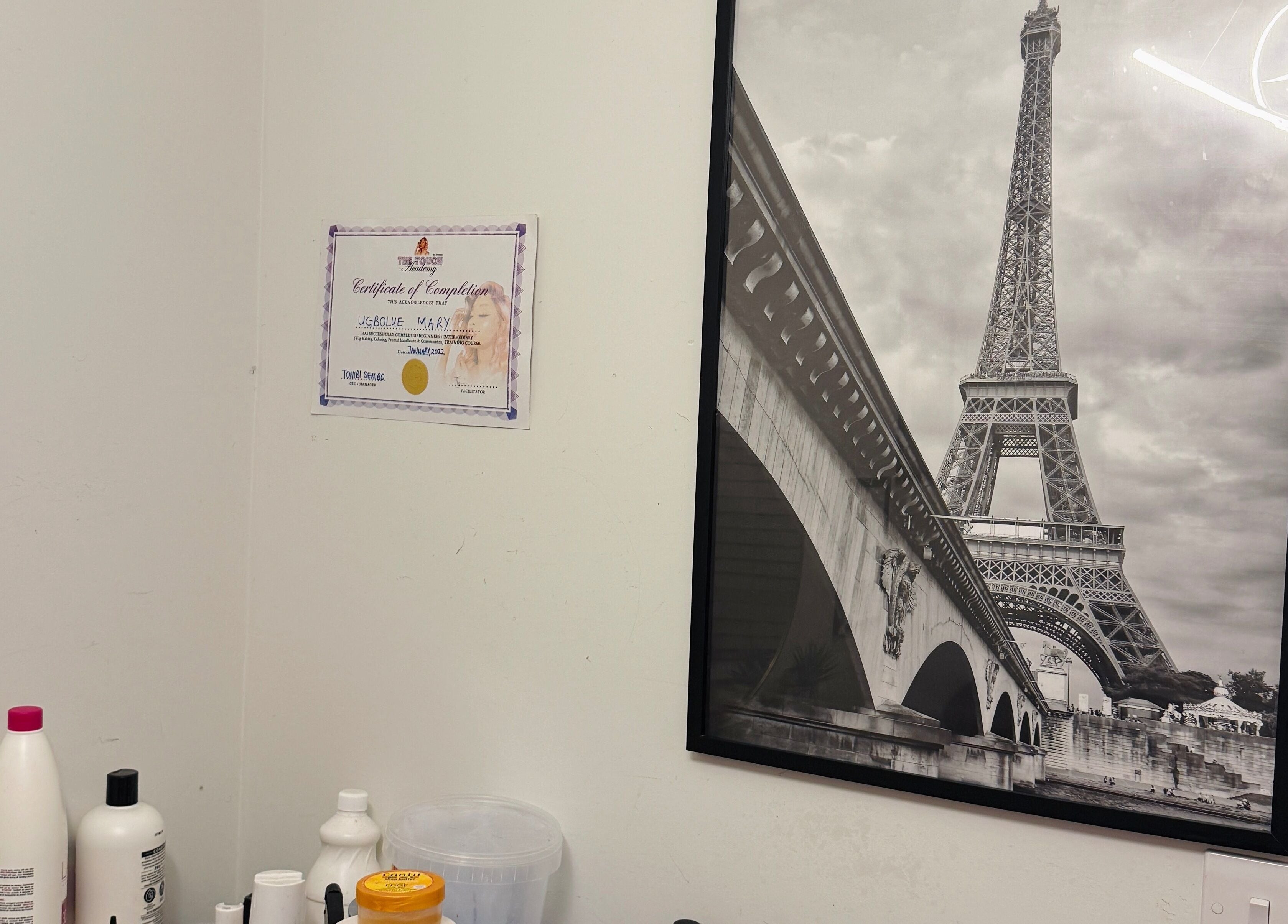 Certificate and Eiffel Tower artwork at Mimis Haven Hub LTD, Leeds, England, GB wellness salon.