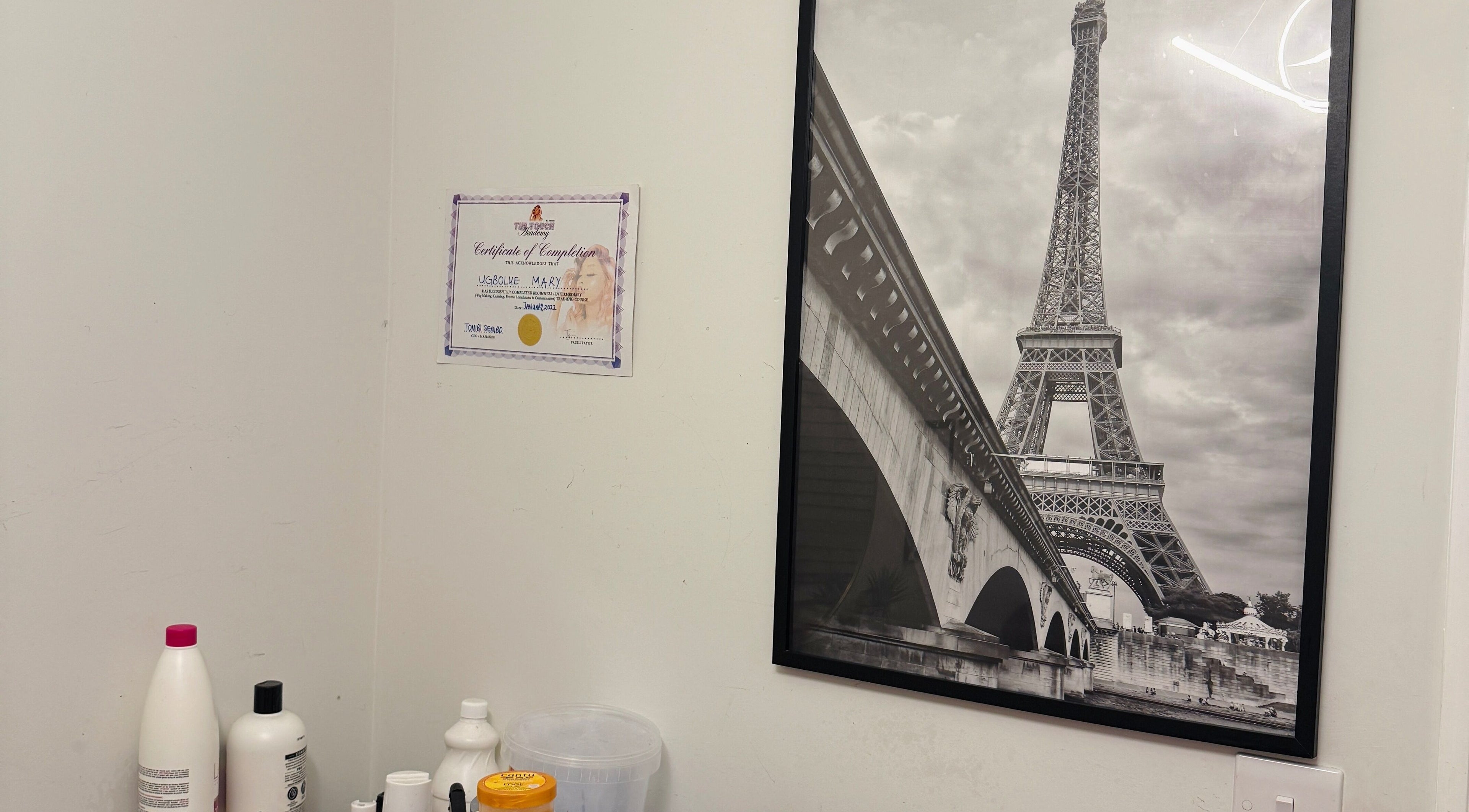 Certificate and Eiffel Tower artwork at Mimis Haven Hub LTD, Leeds, England, GB wellness salon.