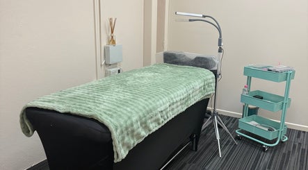 Cozy treatment room at Fancy Lashes TSV in Aitkenvale, Queensland, AU, featuring a plush bed and modern decor.