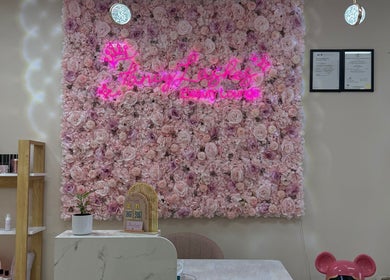 Fancy Lashes TSV reception with pink floral wall in Aitkenvale, Queensland, AU.