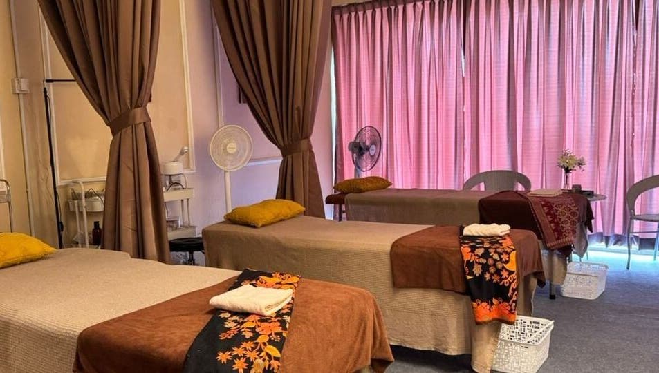 Calming massage room at Bidan Cantik Spa in Sungai Petani, Kedah, MY, featuring soft lighting and comfortable tables.